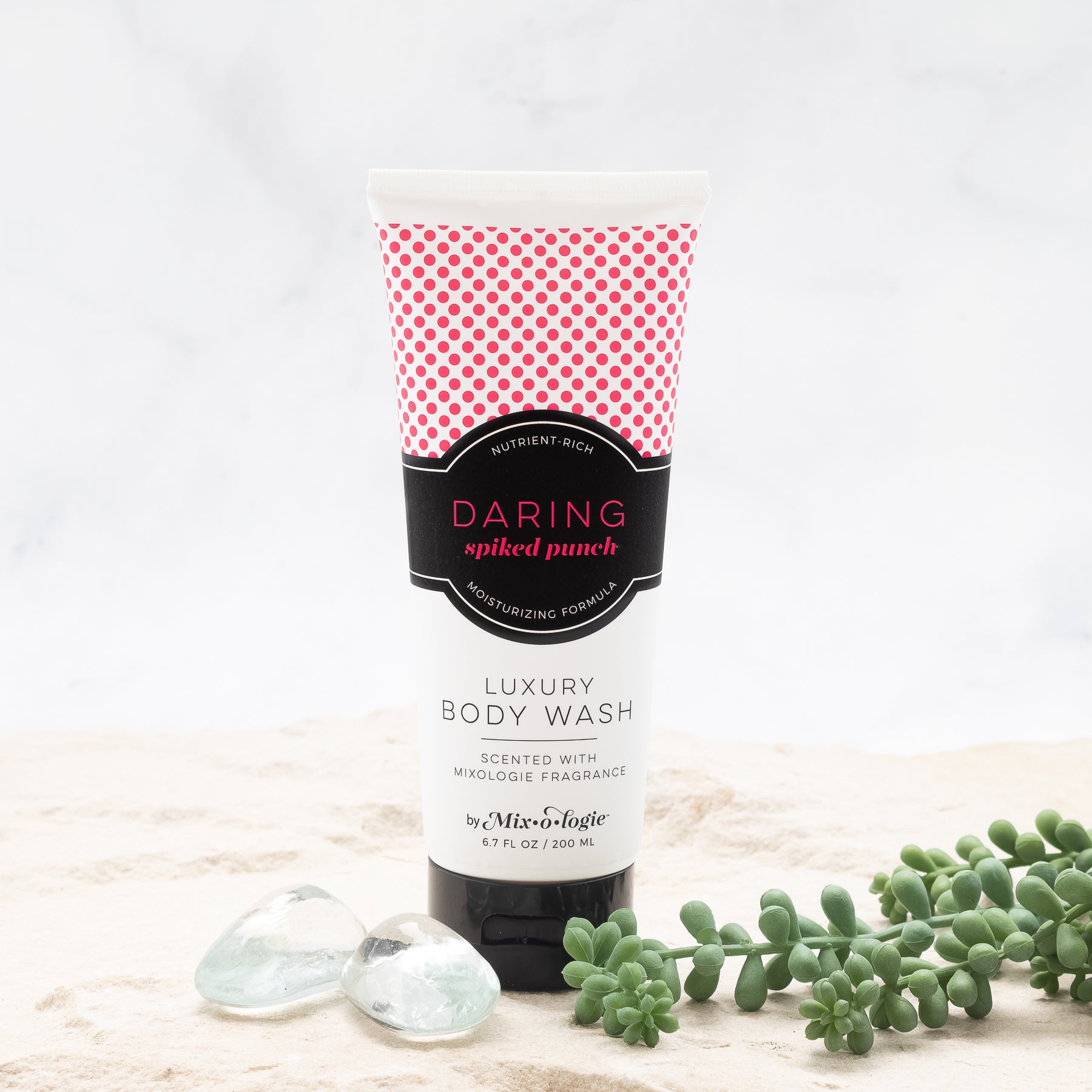 Luxury Body Wash in Mixologie’s Daring (Spiked Punch) in bright pink color sample package with black label. Contains 6.7 fl oz or 200 mL pictured on a white background. 