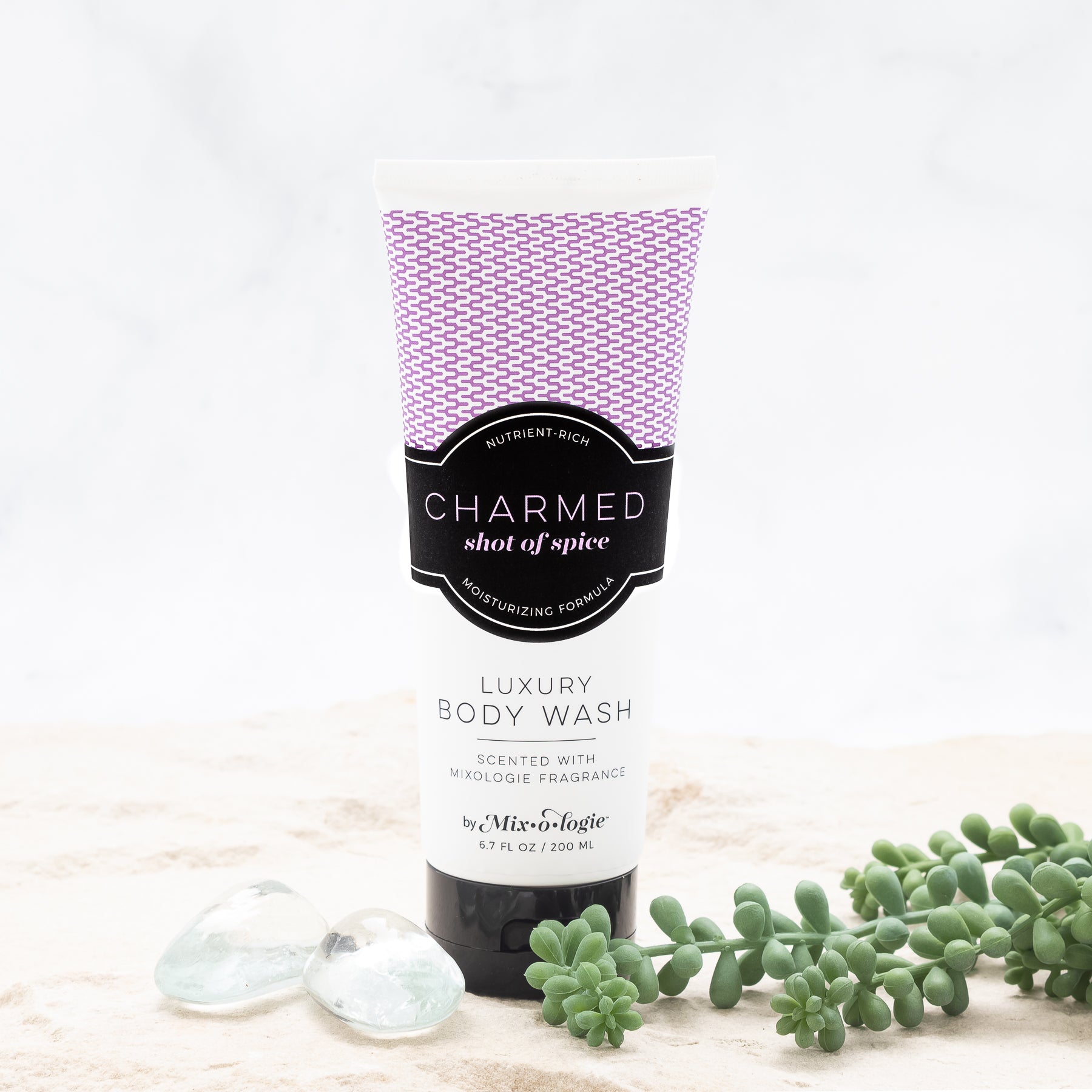 Luxury Body Wash in Mixologie’s Chamred (Shot of Spice) in purple color sample package with black label. Contains 6.7 fl oz or 200 mL pictured on a white background. 