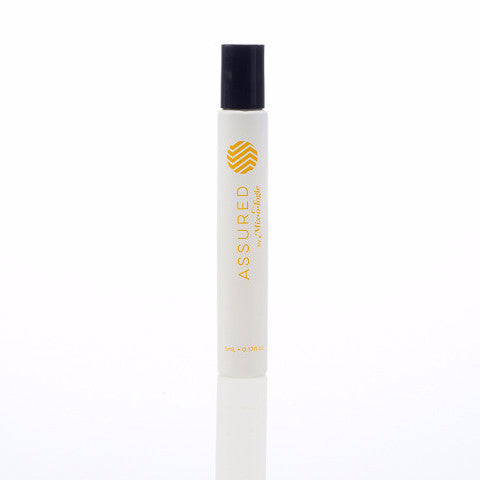 Assured (Natural) white cylinder rollerball with mustard color lettering. Rollerball has 0.17 fl oz or 5 mL. Rollerball pictured with white background. 