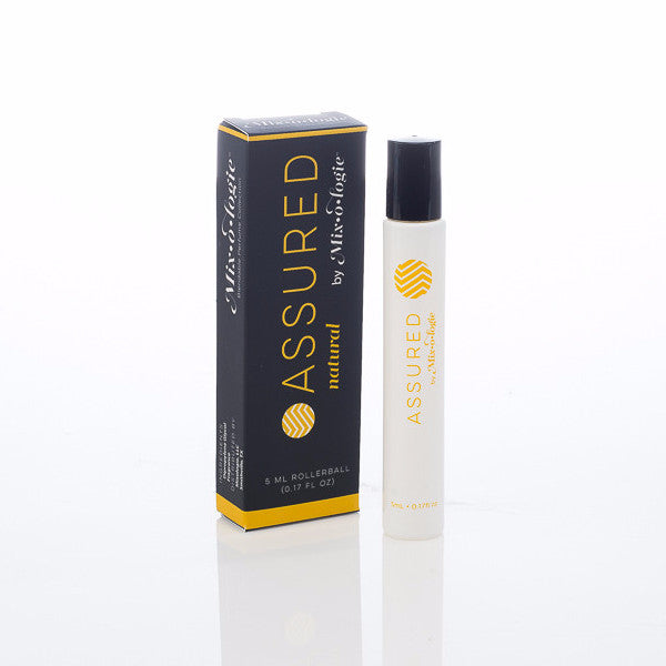 Assured (Natural) white cylinder rollerball with mustard color lettering with black box and mustard color lettering. Rollerball has 0.17 fl oz or 5 mL. Rollerball and rollerball box pictured on a white background
