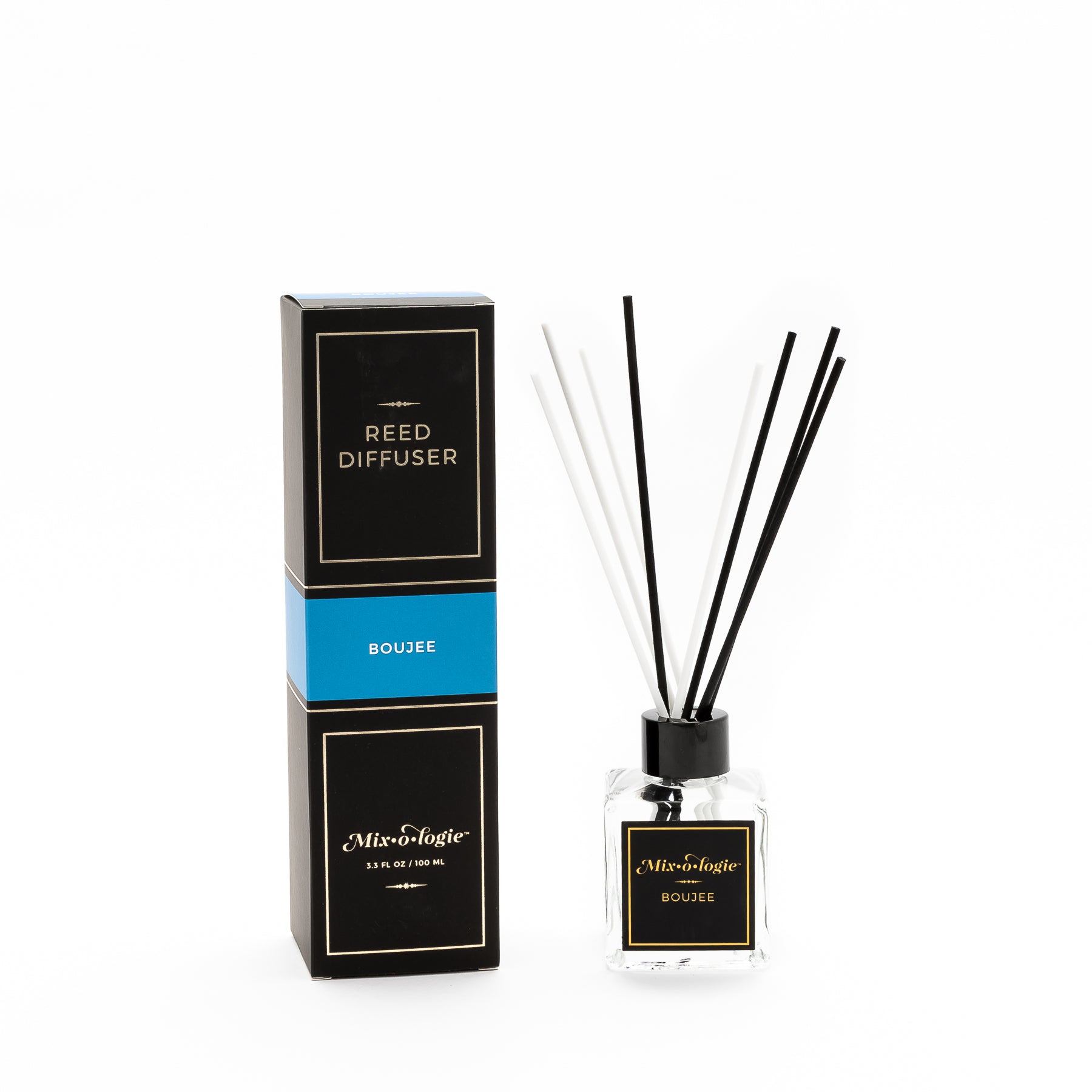 Boujee Reed Diffuser is a clear square glass container with black label that says Mixologie – Boujee. Has a black top and 4 white & 4 black reed sticks coming out of top, is 3.3 fl oz or 100 mL of clear scented liquid. Black rectangle package box with blue label. Box and diffuser are pictured with white background.