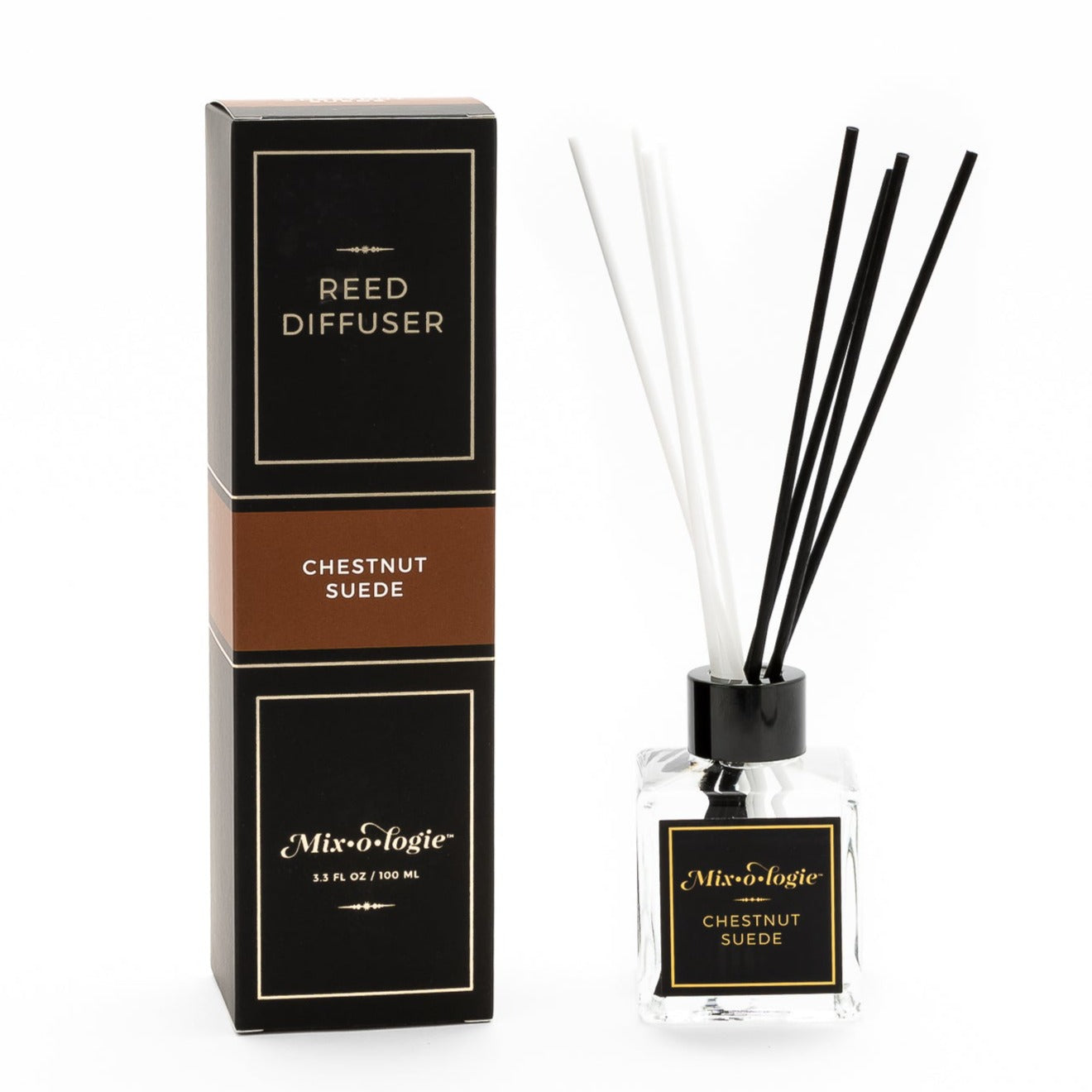 Chestnut Suede Reed Diffuser is a clear square glass container with black label that says Mixologie – Chestnut Suede. Has a black top and 4 white & 4 black reed sticks coming out of top, is 3.3 fl oz or 100 mL of clear scented liquid. Black rectangle package box with brown label. Box and diffuser are pictured with white background.