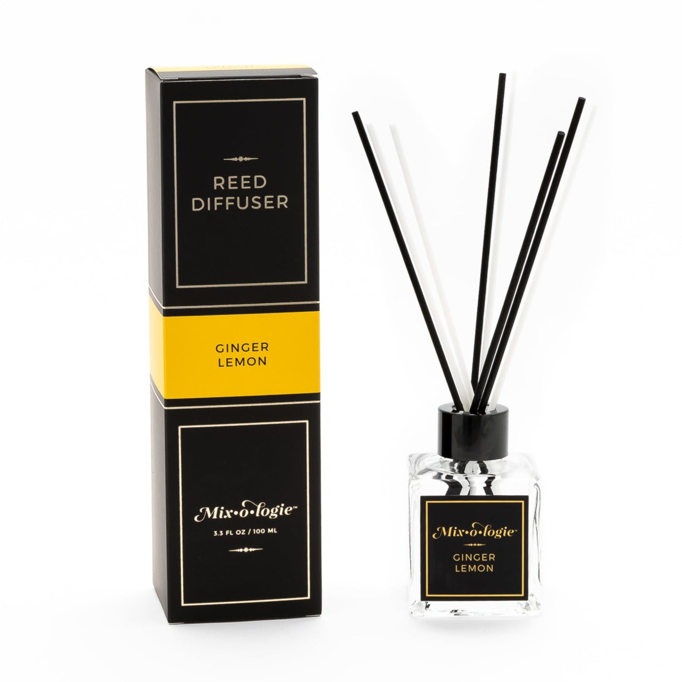 Ginger Lemon Reed Diffuser is a clear square glass container with black label that says Mixologie – Ginger Lemon. Has a black top and 4 white & 4 black reed sticks coming out of top, is 3.3 fl oz or 100 mL of clear scented liquid. Black rectangle package box with mustard label. Box and diffuser are pictured with white background.