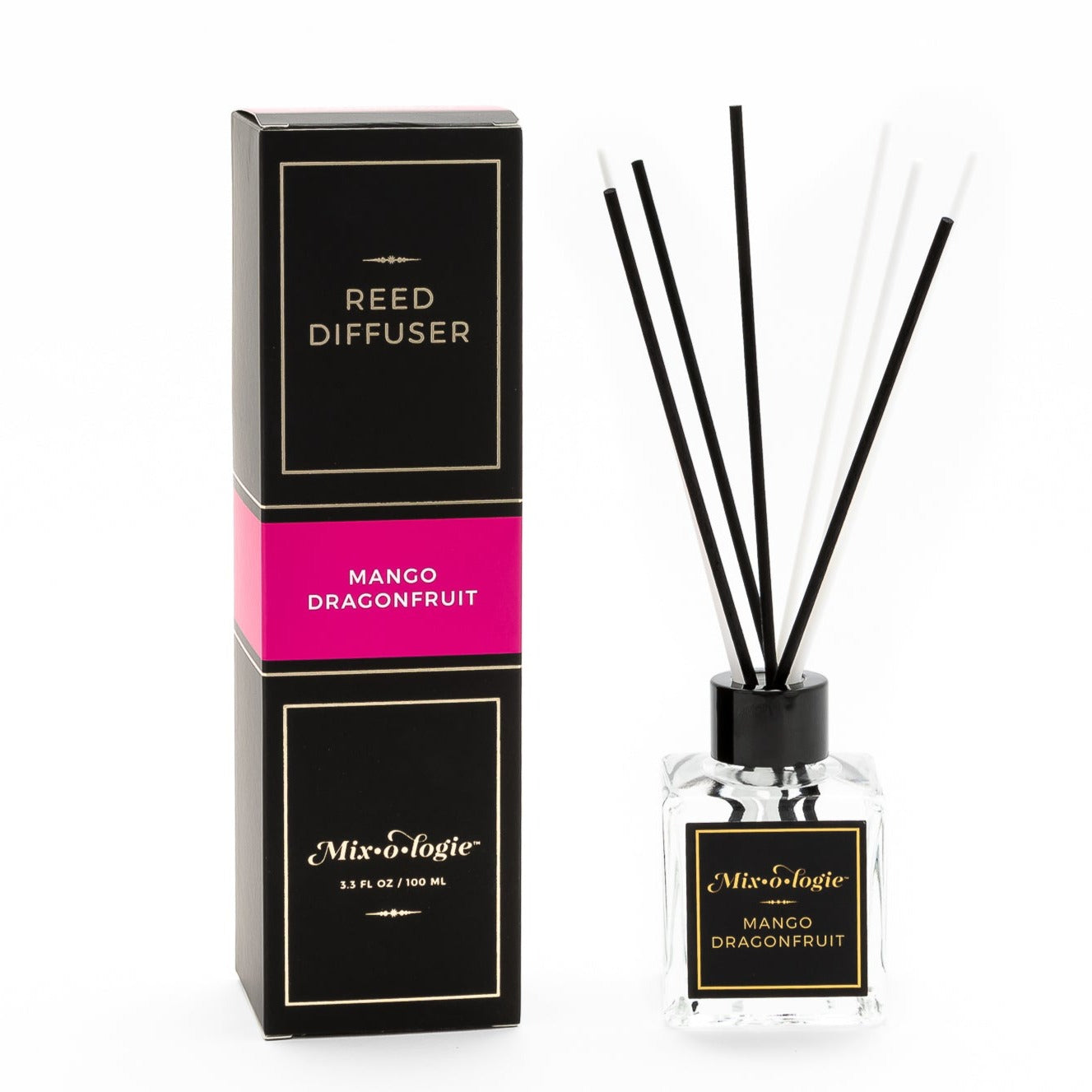 Mango Dragonfruit Reed Diffuser is a clear square glass container with black label that says Mixologie – Mango Dragonfruit. Has a black top and 4 white & 4 black reed sticks coming out of top, is 3.3 fl oz or 100 mL of clear scented liquid. Black rectangle package box with bright pink label. Box and diffuser are pictured with white background.