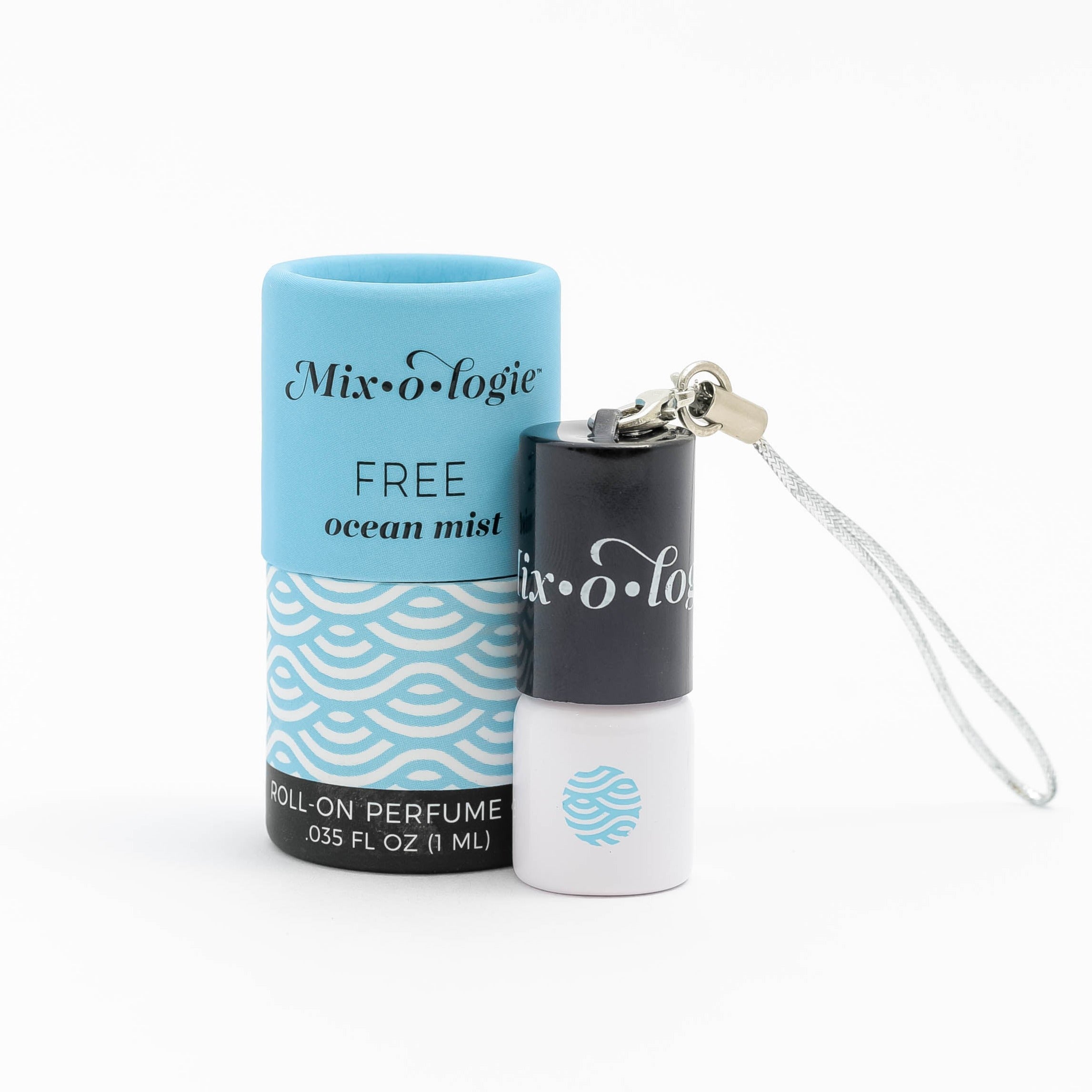 Free (Ocean Mist) mini white cylinder rollerballs with black top and keychain attachment with pale blue wave-like pattern and has .035 fl oz or 1 mL. Pale blue cylinder packing tube with pale blue wave-like pattern. Roll-on perfume oil. Mini rollerball and cylinder tube are on a white background.